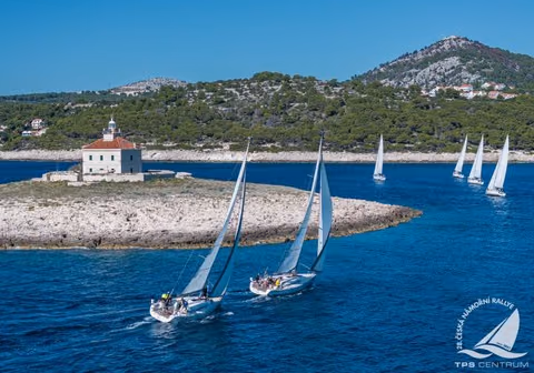 Czech Sailing Rally yachts rounding a lighthouse islet off the Croatian coast